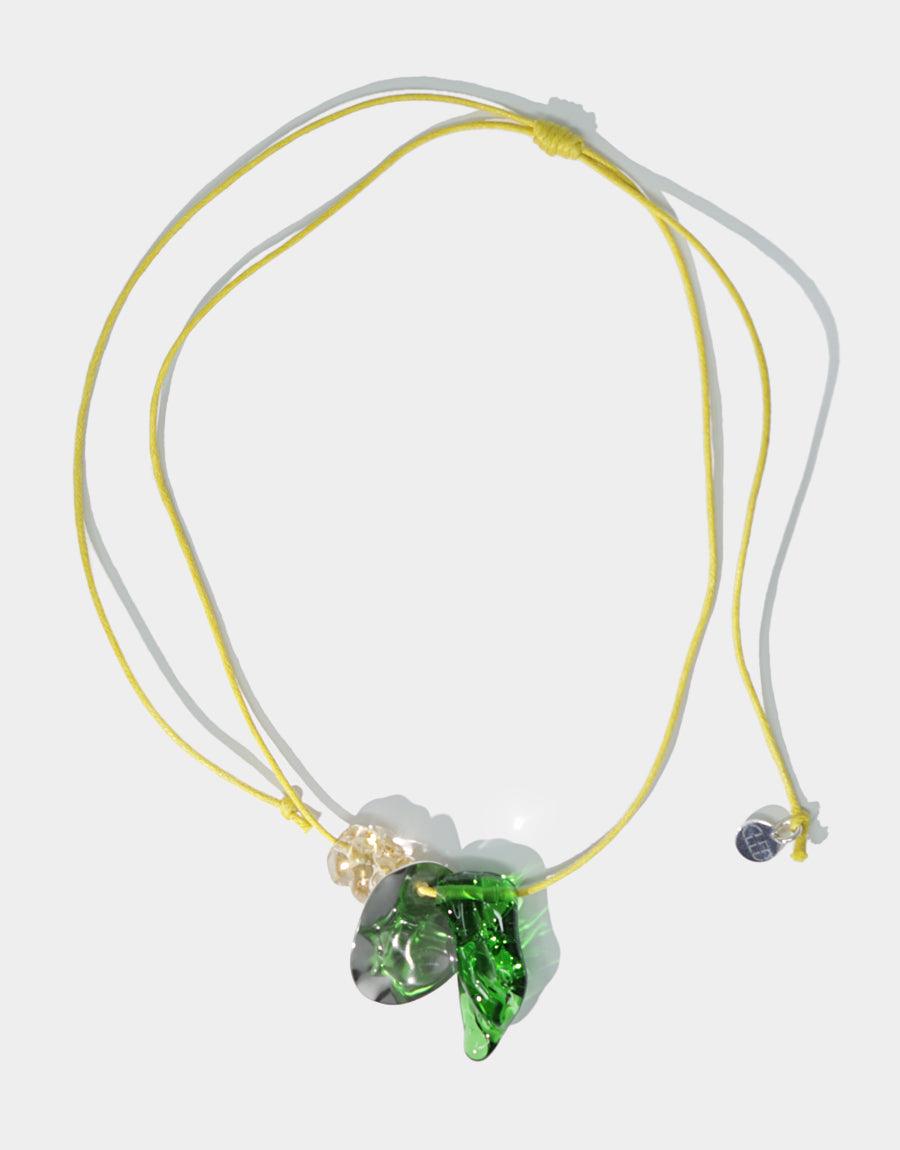 Amorphous Long Cluster Necklace featuring adjustable yellow and gray cords with green glass gem charms, gold and pearl accents, and wavy disc pendant. Handcrafted sustainable jewelry showcasing repurposed glass and sterling silver elements. CLED