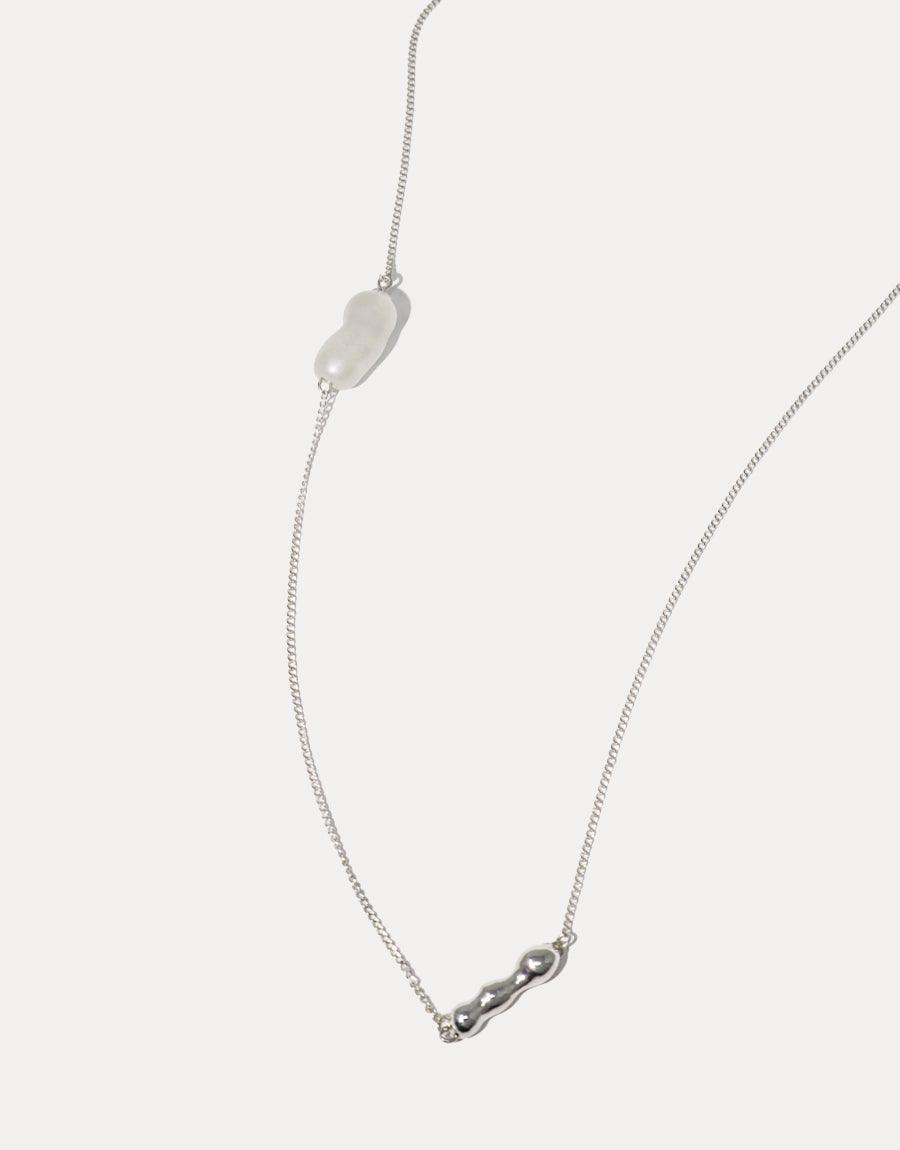 Elegant Shoreline Long Necklace featuring delicate silver chain with two unique pendants: a translucent water drop and a sustainable pearl Eco Gem. Minimalist design perfect for layering or standalone wear. Handcrafted sterling silver necklace by CLED.