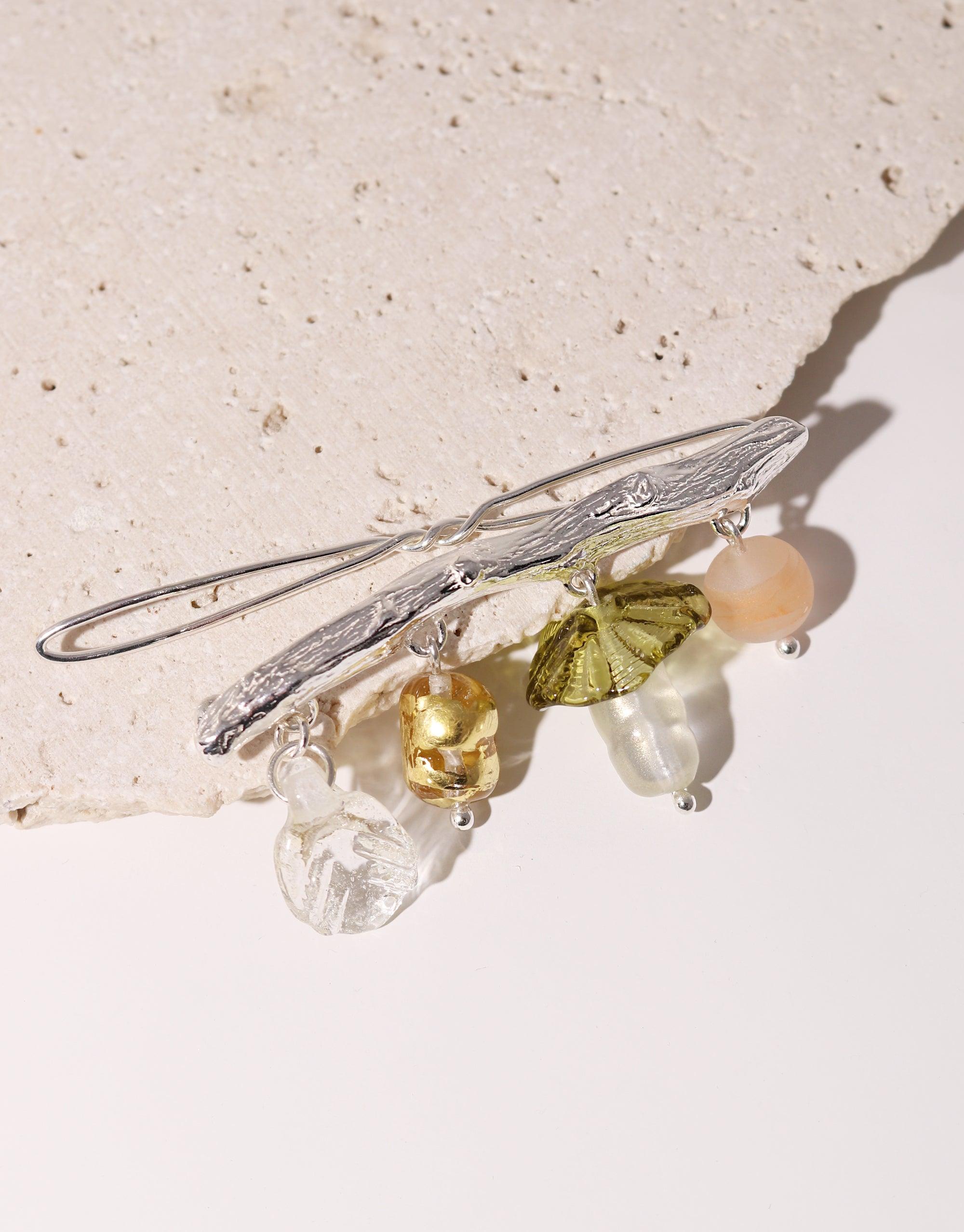 Elegant Floral Barrette with delicate silver metalwork and colorful eco-friendly glass beads in shades of green, yellow, and clear, showcasing sustainable craftsmanship and spring-inspired design. Handmade hair accessory perfect for adding a touch of nature-inspired glamour. CLED Floral Barrette.