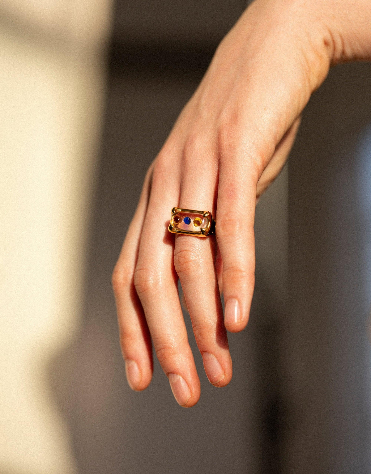 Hand wearing Prism Ring in Sterling Silver with colorful eco gems, showcasing unique design inspired by light refraction. Sustainable jewelry piece by CLED featuring upcycled glass. Prism Ring | Sterling Silver