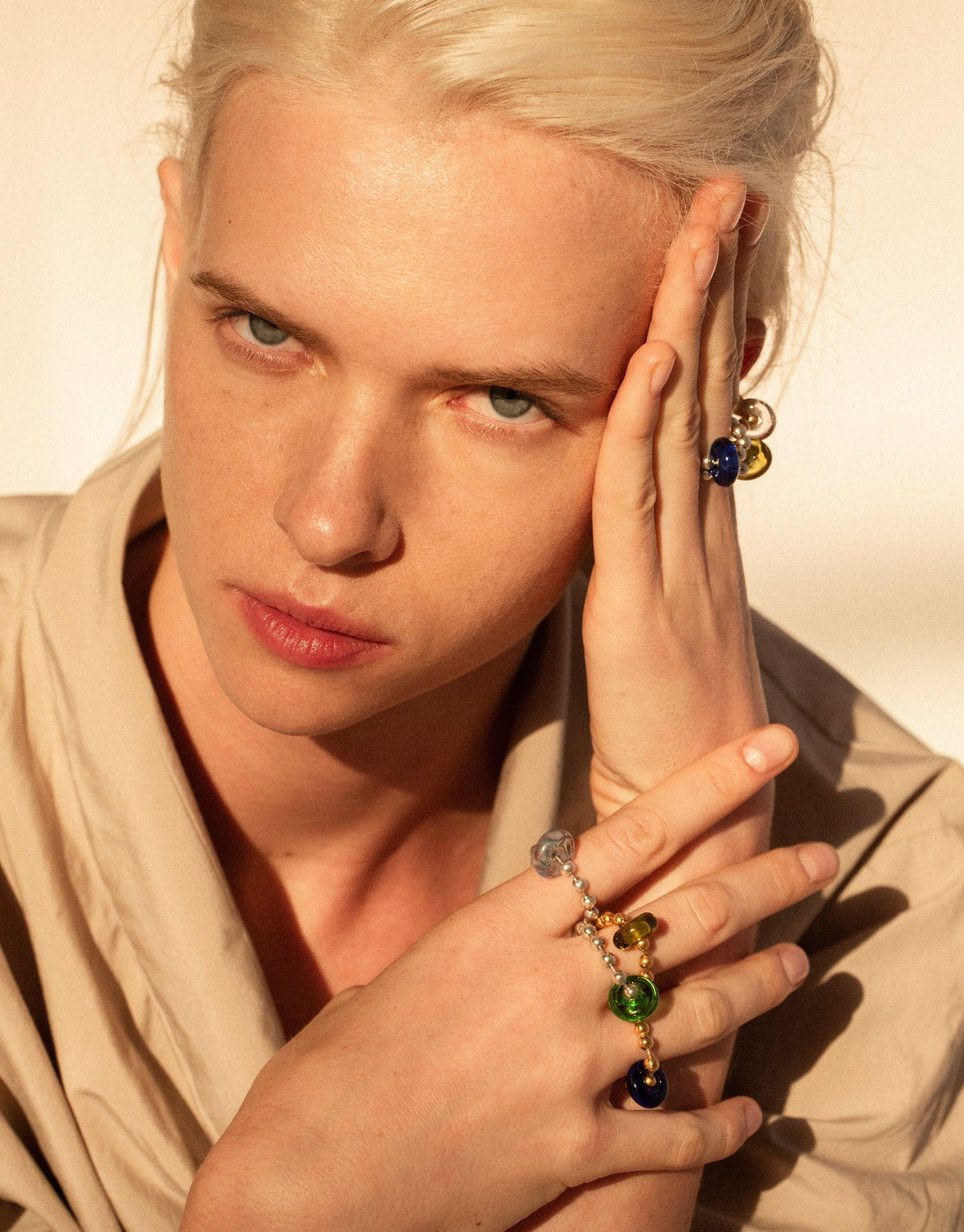 Stylish model wearing Donut Ball Ring with colorful eco gems, showcasing prismatic effect of upcycled glass jewelry. Hand positioned to highlight ring's unique design and sustainable materials. Elegant and eco-conscious accessory by CLED.