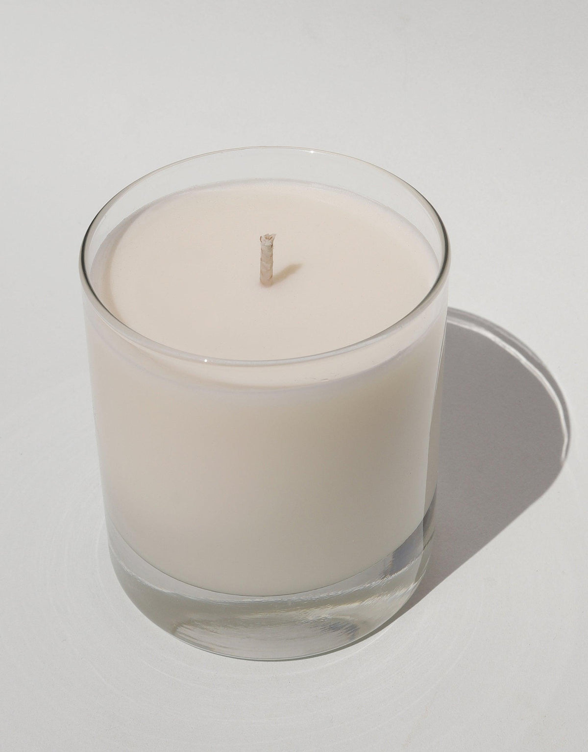 LAIT X SHIPPE X CLED Vessel & Candle featuring a glass container with white soy wax candle and cotton wick. Minimalist design showcasing handcrafted, eco-friendly materials for sustainable home decor and aromatherapy. Collaborative product emphasizing upcycling and circular design. CLED
